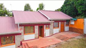 a house with red and white at Comfort Inn Nyeri in Nyeri