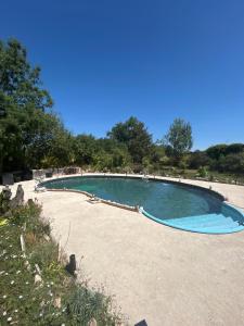 a large swimming pool in the middle of a yard at Maison en pierre in Saint-Cyr +10 photos