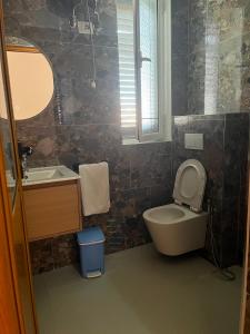 a bathroom with a toilet and a sink at Kapo Residence in Vlorë