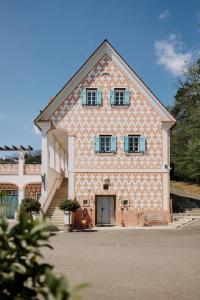 a large building with blue windows and a door at Weingut Bleyweis in Kitzeck im Sausal