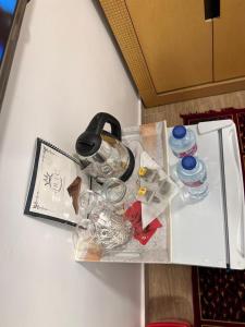 a table with bottles and other items on it at Phoenix Pyramids Inn in Banī Ghālib +16 photos