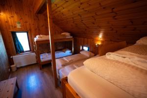 a bedroom with two bunk beds in a wooden cabin at Laugarfell Accommodation & Hot Springs in Laugarfell