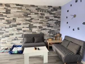 a living room with a couch and a table at La Caleya de Ozanes in Ozanes +12 photos