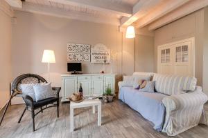 a living room with a couch and a chair at Cascina Arcangelo Raffaele in Verduno