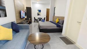 a living room with a couch and a bed and a table at Imperio A1910 Studio Bathtud Netflix Parking in Malacca