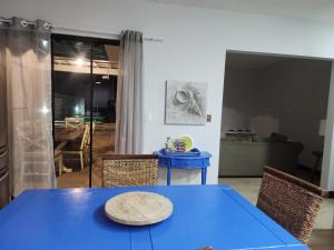 a blue table and chairs in a living room at Casa Casal Itapoá in Itapoa +4 photos