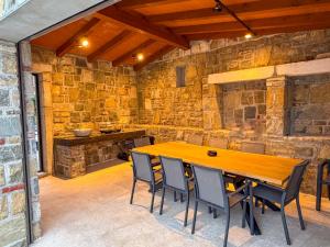 a dining room with a wooden table and chairs at Gloria Holiday - Casa Bianca in Piran
