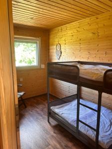 a room with two bunk beds in a log cabin at Luční domek in Protivín