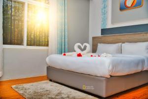 a bedroom with a bed with a heart stuffedanimal on it at Saffron Inn Luxury Hotel in Marsabit