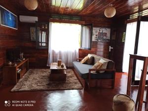 a living room with a couch and a window at Chalet Bois Luxe in Nosy Be