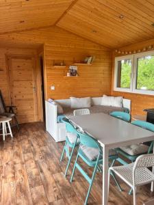 a dining room with a table and chairs at Luční domek in Protivín