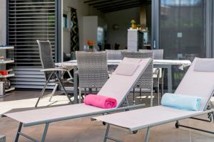 a group of chairs with colorful cushions sitting on them at Freiraum Urlaubsapartment in Villach