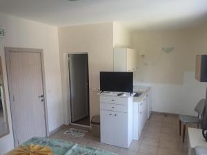 a room with a white desk with a television on it at Apartments Ivelin in Lozenets