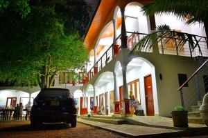 a car parked in front of a building at Lucas in Bentota