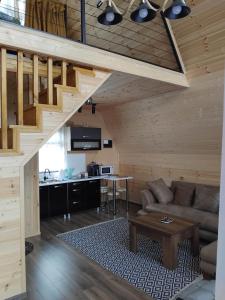 a living room with a couch and a table at Cottage MTIS DZIRSHI in Ach'khoti