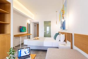 a bedroom with a bed and a laptop on a desk at Limenaria Beach in Limenaria