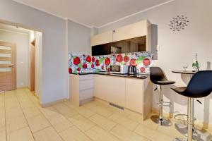 a kitchen with a counter and a table and chairs at Villa Arkodes in Gdańsk