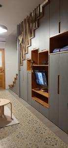 a kitchen with white cabinets and a staircase at The Yemen pearl in Tel Aviv