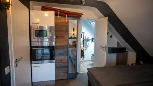 a small kitchen with a refrigerator and a staircase at Ferienwohnung Xantener Südsee in Xanten