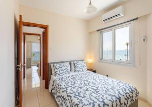 a bedroom with a bed with a view of the ocean at Lighthouse Seafront Panorama - Kato Paphos Central in Paphos