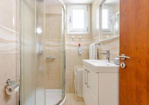 a bathroom with a shower and a sink at Lighthouse Seafront Panorama - Kato Paphos Central in Paphos +64 photos