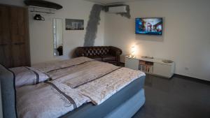a bedroom with a large bed and a chair at Ferienwohnung Xantener Südsee in Xanten