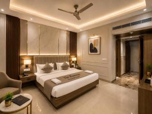 a bedroom with a large bed with a ceiling fan at The Runway Corporate Hotel IGI Delhi Airport Terminal-3 With Free Airport Pickup in New Delhi +16 photos