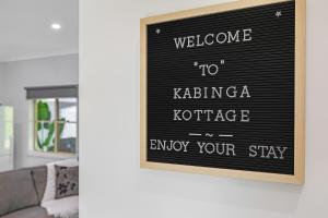 a sign that reads welcome to katerina kotezie enjoy your stay at Kabinga Kottage - Echuca Holiday Homes in Moama