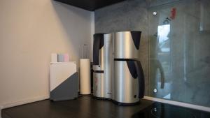 a kitchen counter with two stainless steel appliances on it at Ferienwohnung Xantener Südsee in Xanten