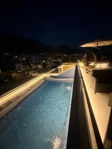 a swimming pool on top of a building at night at Apartments Pericic LUX in Sutomore