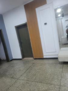 an empty room with a door and a couch at Mohe's place in Ilorin
