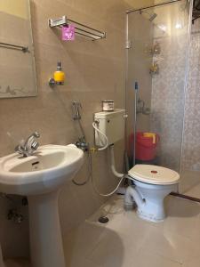 a bathroom with a toilet and a sink and a shower at Homestay in Varanasi +37 photos