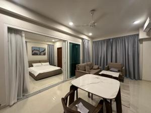 a bedroom with a bed and a table and a couch at The Oceanview Grand at Hulumale and Male in Hulhumale +86 photos
