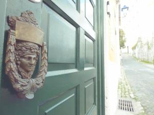 a door with a statue of a head on it at Sintra1012 Boutique Guesthouse in Sintra