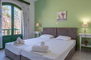a bedroom with a large bed with towels on it at Bellevue Apartments in Sitia