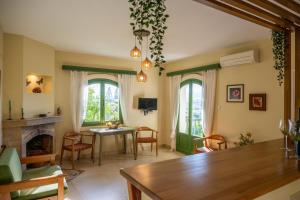 a living room with a table and a fireplace at Bellevue Apartments in Sitia