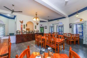 a dining room with wooden tables and chairs at Sariska Forest Trail in Rāmsinghpura