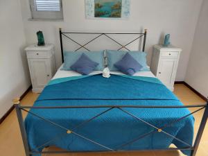 a bedroom with a blue bed with blue pillows at B & B Villa Matisse in Laureana Cilento +149 photos
