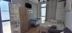 a small bedroom with a bed and a window at ZARAUTZ LOFT 1 in Zarautz