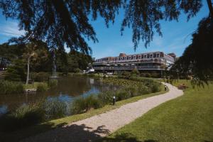 a building next to a river with a building at St. Pierre Park Hotel & Golf in St. Peter Port