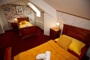 a bedroom with two beds and two night stands at Hotel Paříž in Jičín