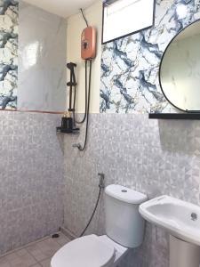 a bathroom with a toilet and a sink at Home No 3 khanom in Ban Thung O +26 photos