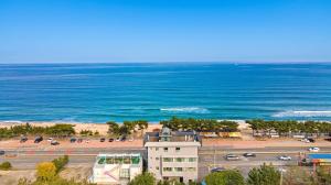 an aerial view of a parking lot next to the ocean at Baradeon Bada Pension, Yangyang in Yangyang
