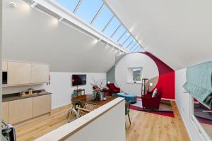 an attic kitchen and living room with a skylight at Papple Steading in East Linton