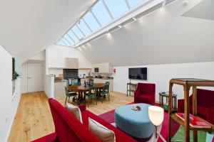 a living room with red chairs and a table at Papple Steading in East Linton