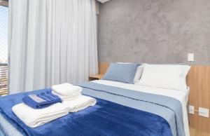 a hotel room with two beds with towels on them at The CityPlex | Apartamentos Prime no Centro de Osasco in Osasco +103 photos