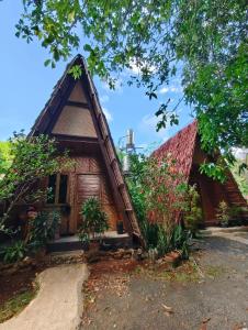 a small house with a thatched roof at travis homestay in Siquijor