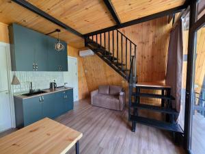 a kitchen with a spiral staircase in a house at Diamond Cottages in Lagodekhi