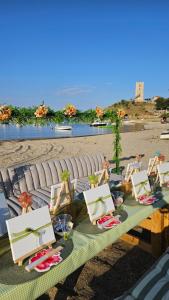 a picnic table with chairs on the beach at Marivar living in Nea Fokea