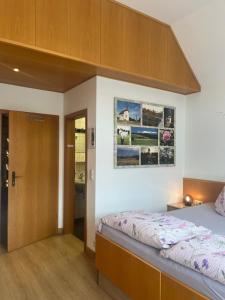 a bedroom with a bed and a wooden cabinet at Gästehaus Jutta / Pension Link in Fladungen